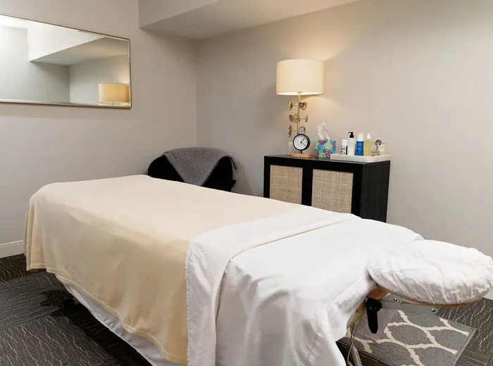 Private treatment room with a made-up table and lamp